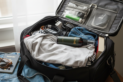 Filthé fabric mist on messy travel bag with wrinkled t-shirt